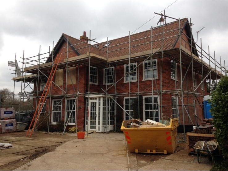 Scaffolding around a large brick house